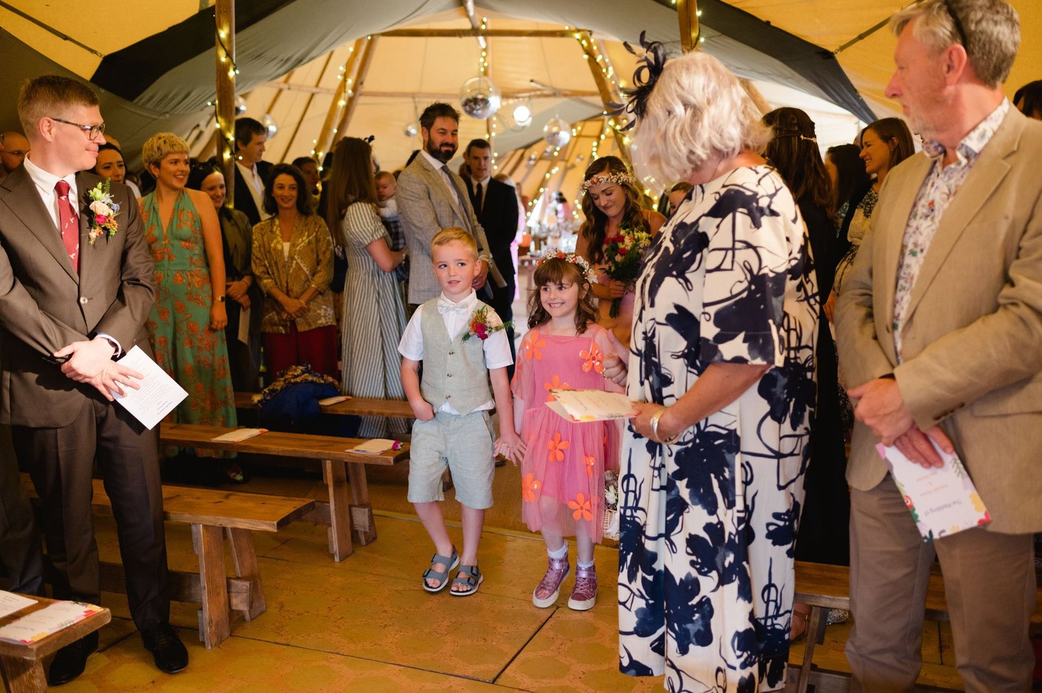 Children standing in the aisle during the wedding ceremony