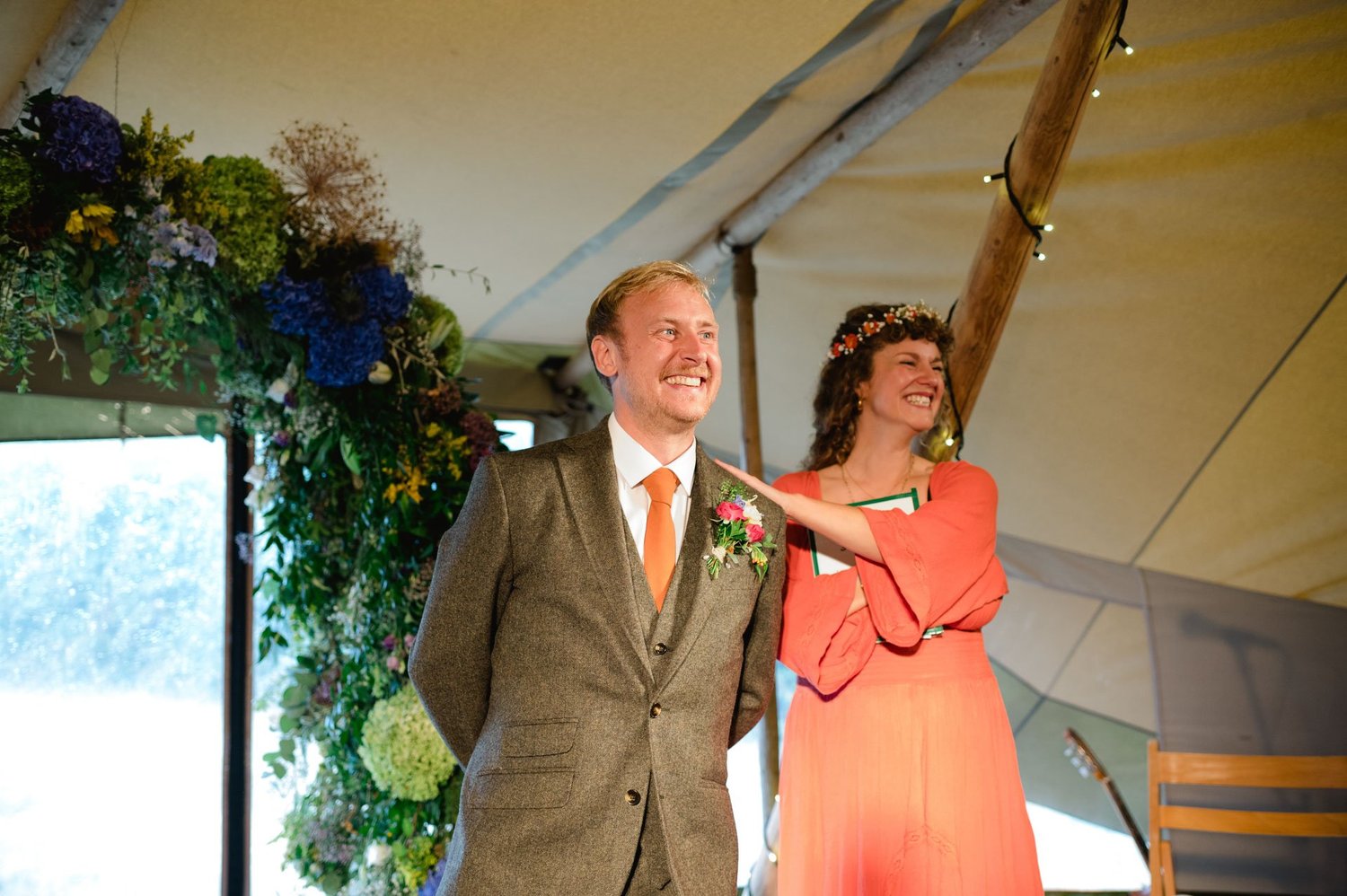 Alex smiling at the front of the tipi before the vows