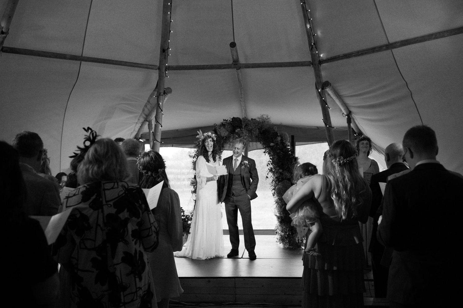 Guests watching the couple at the front of the tipi