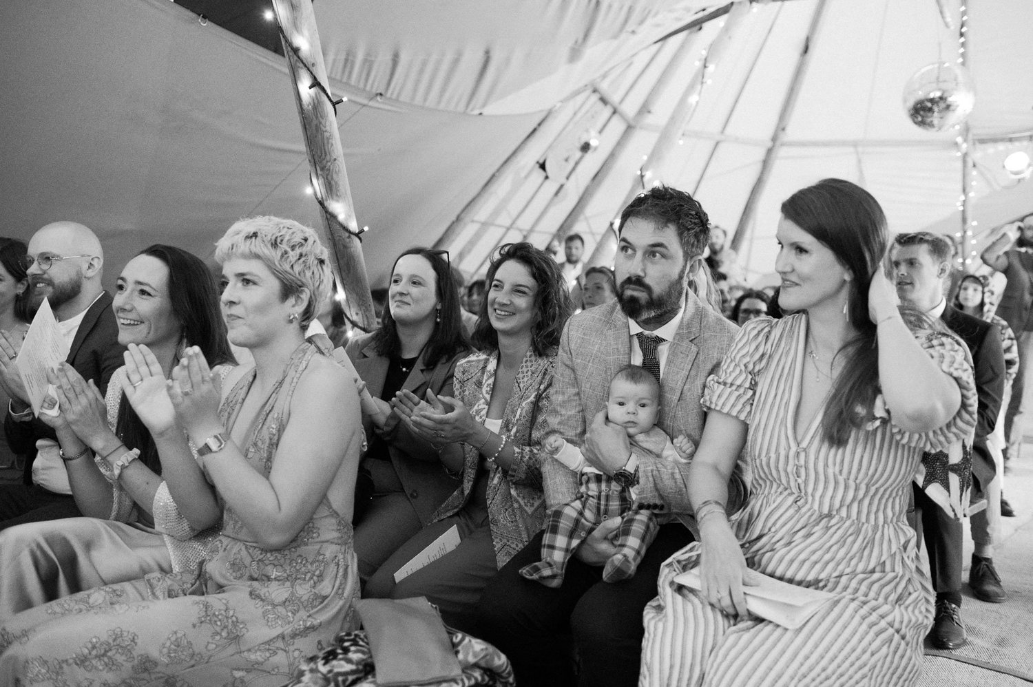 Wedding guests applauding during the tipi wedding ceremony