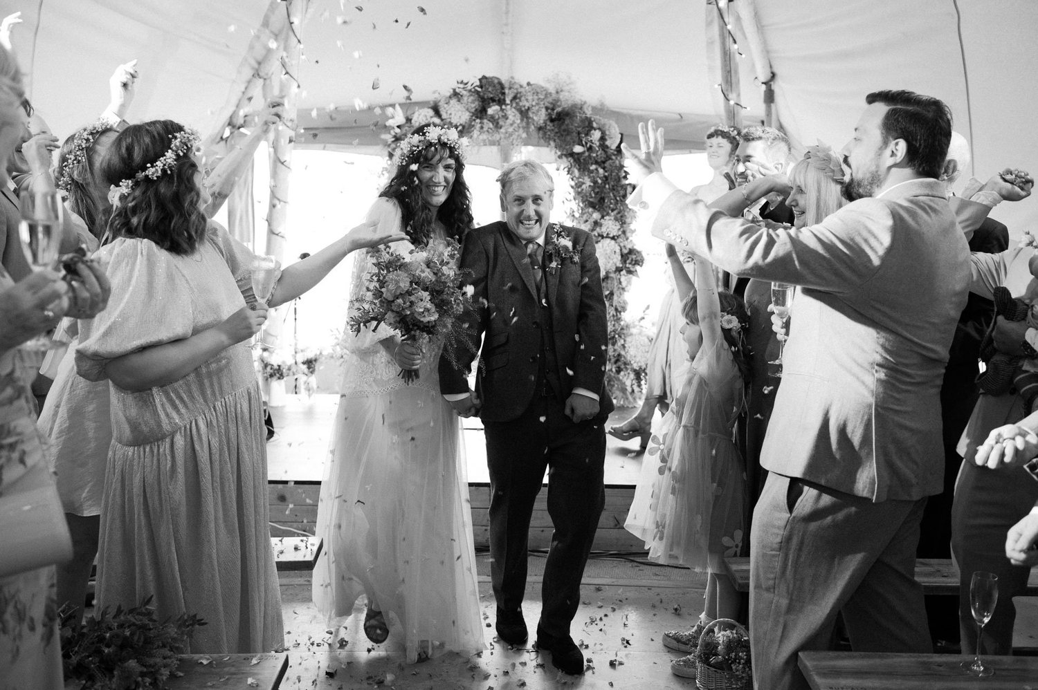 Hannah and Alex walking through confetti after the ceremony