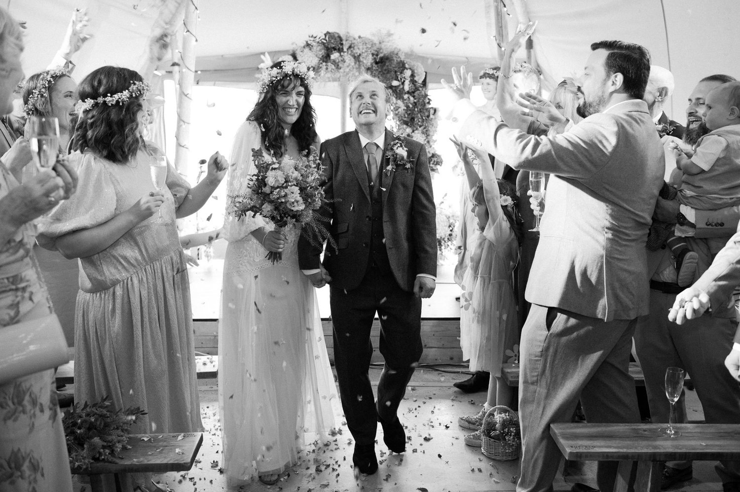 Hannah and Alex leaving the ceremony as guests cheer