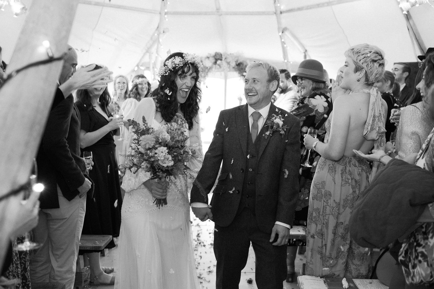 Hannah and Alex smiling in the confetti aisle