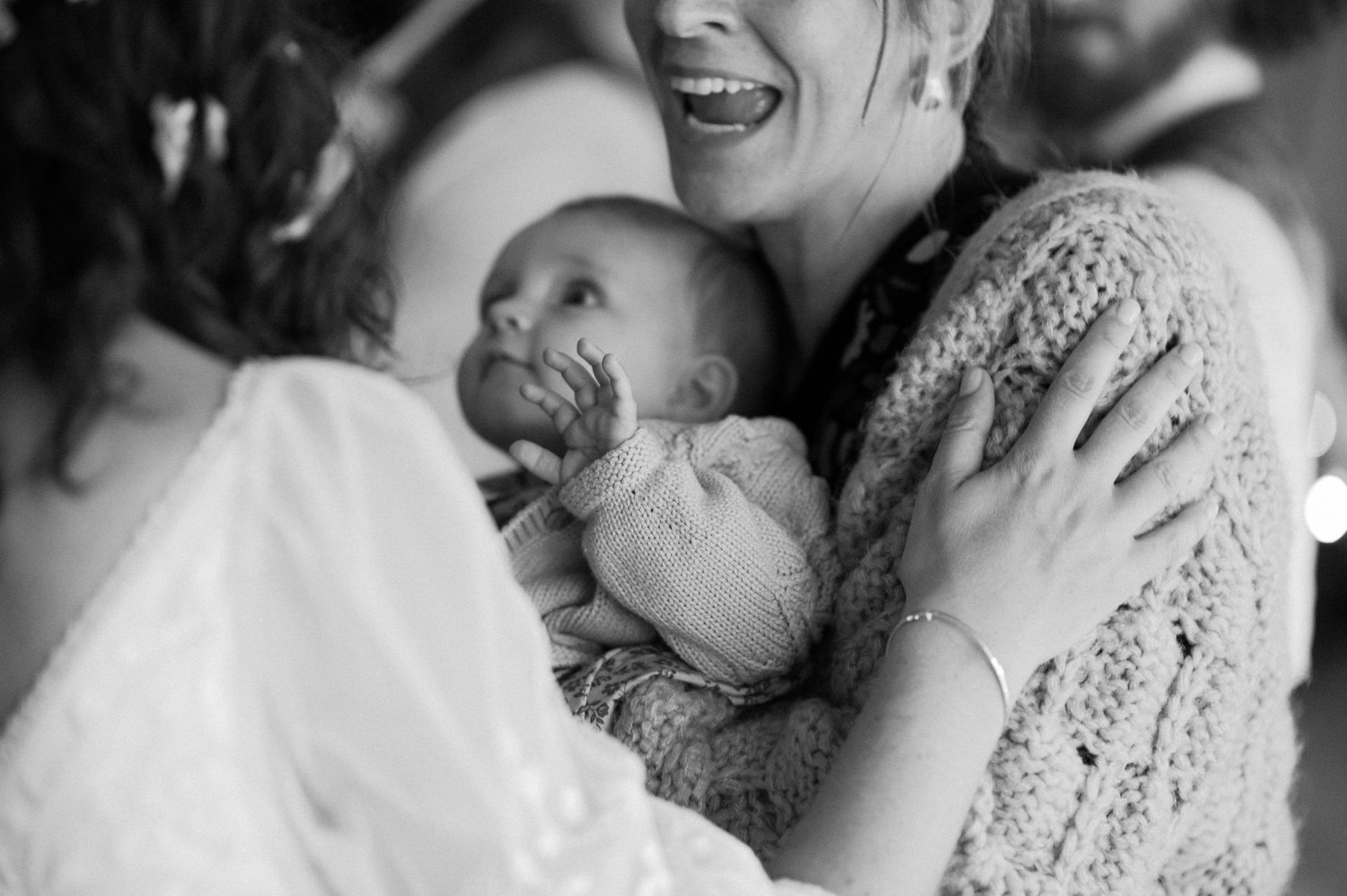 A guest holding a baby during the Frome festival wedding