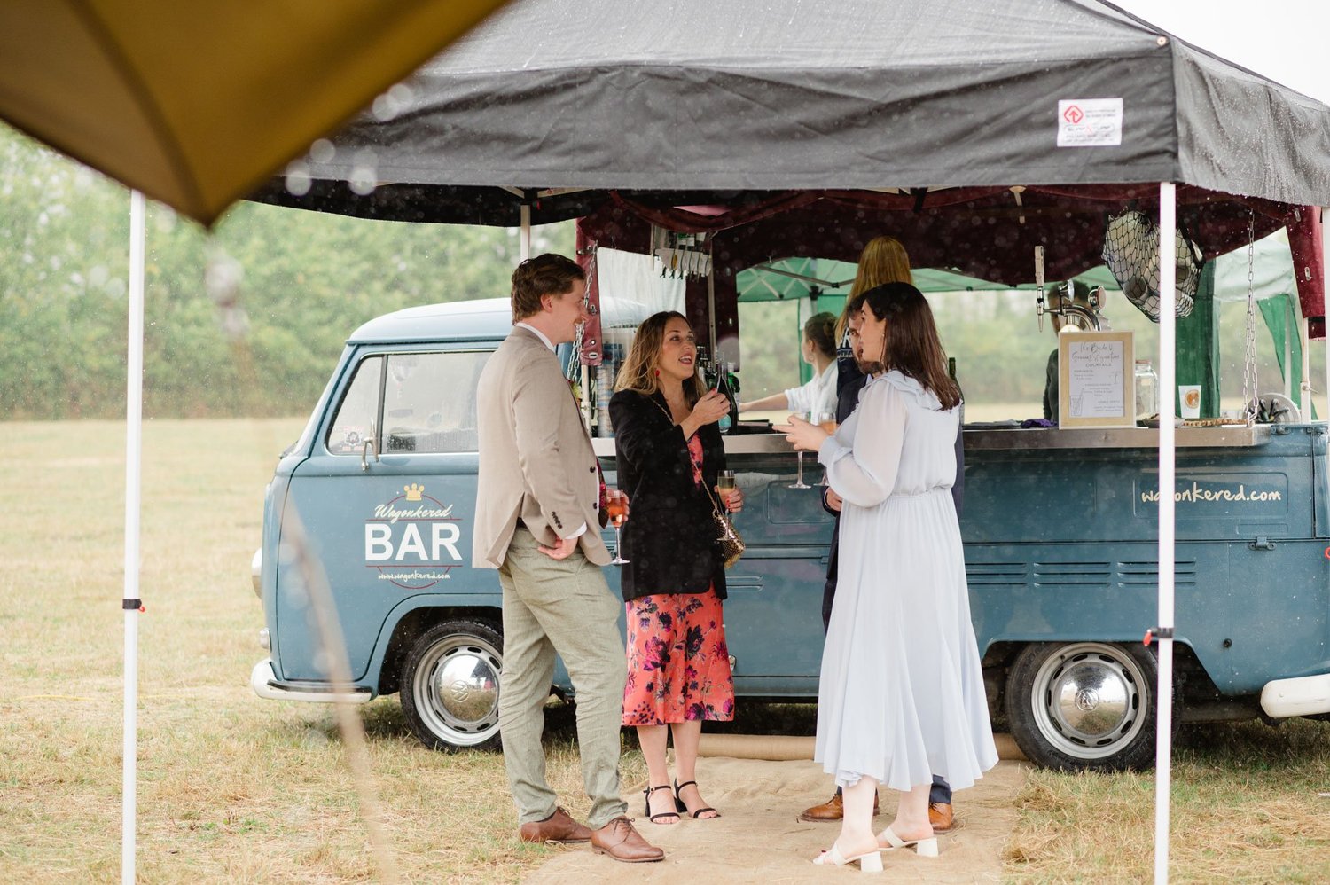Hannah and Alex chatting beside the vintage VW cocktail bar