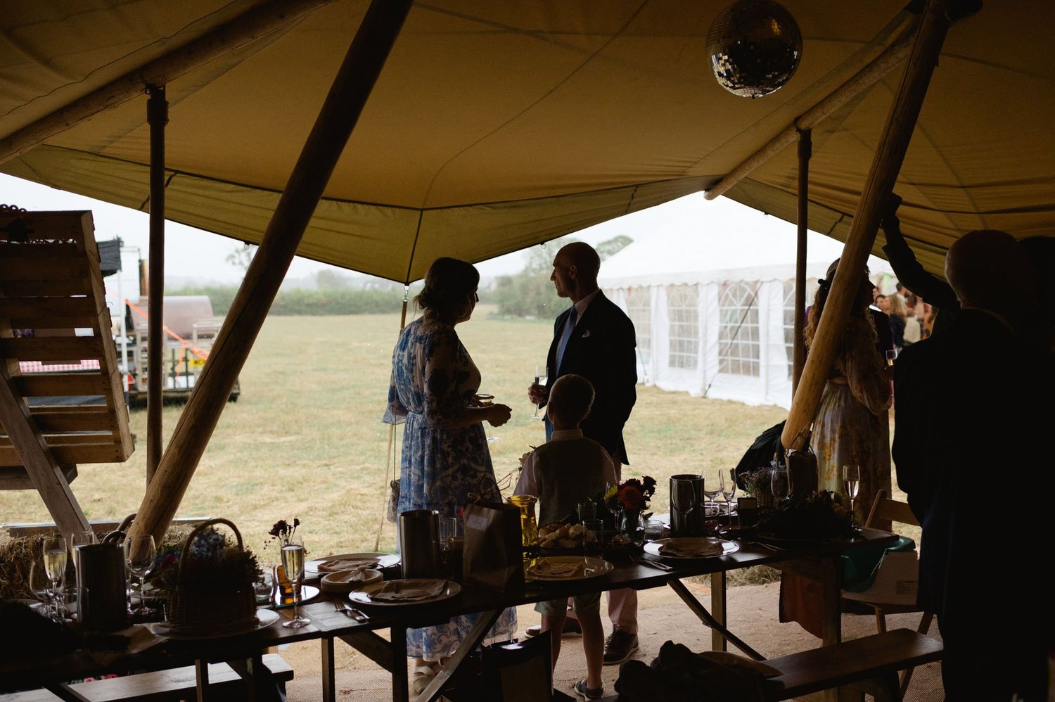 Hannah and Alex silhouetted during a speech in the tipi