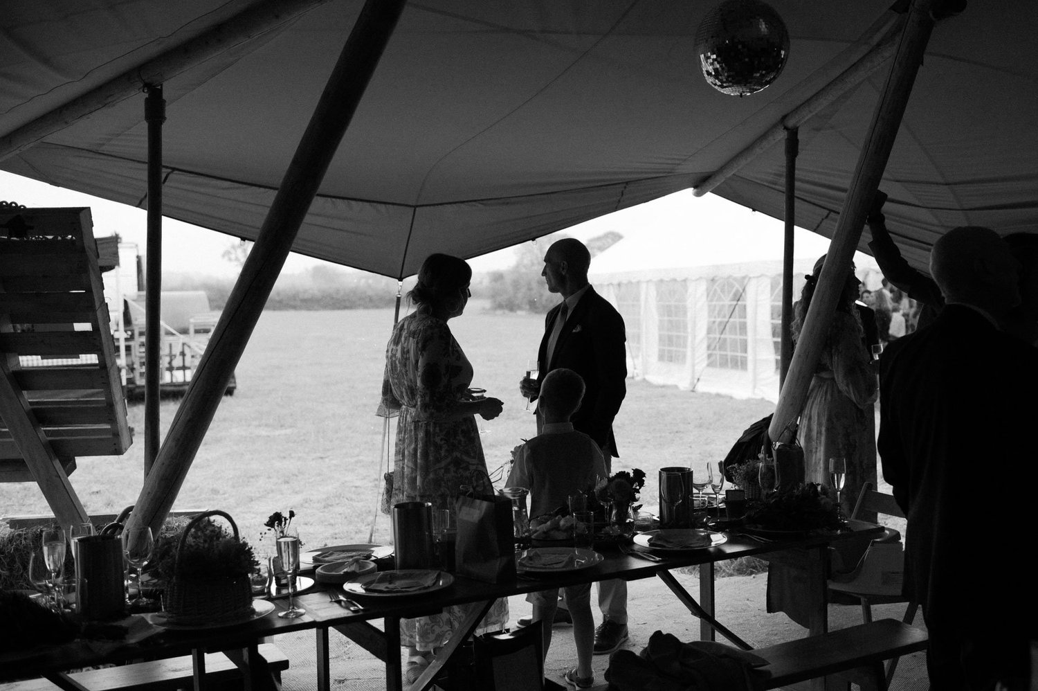 Hannah and Alex silhouetted during speeches inside the tipi