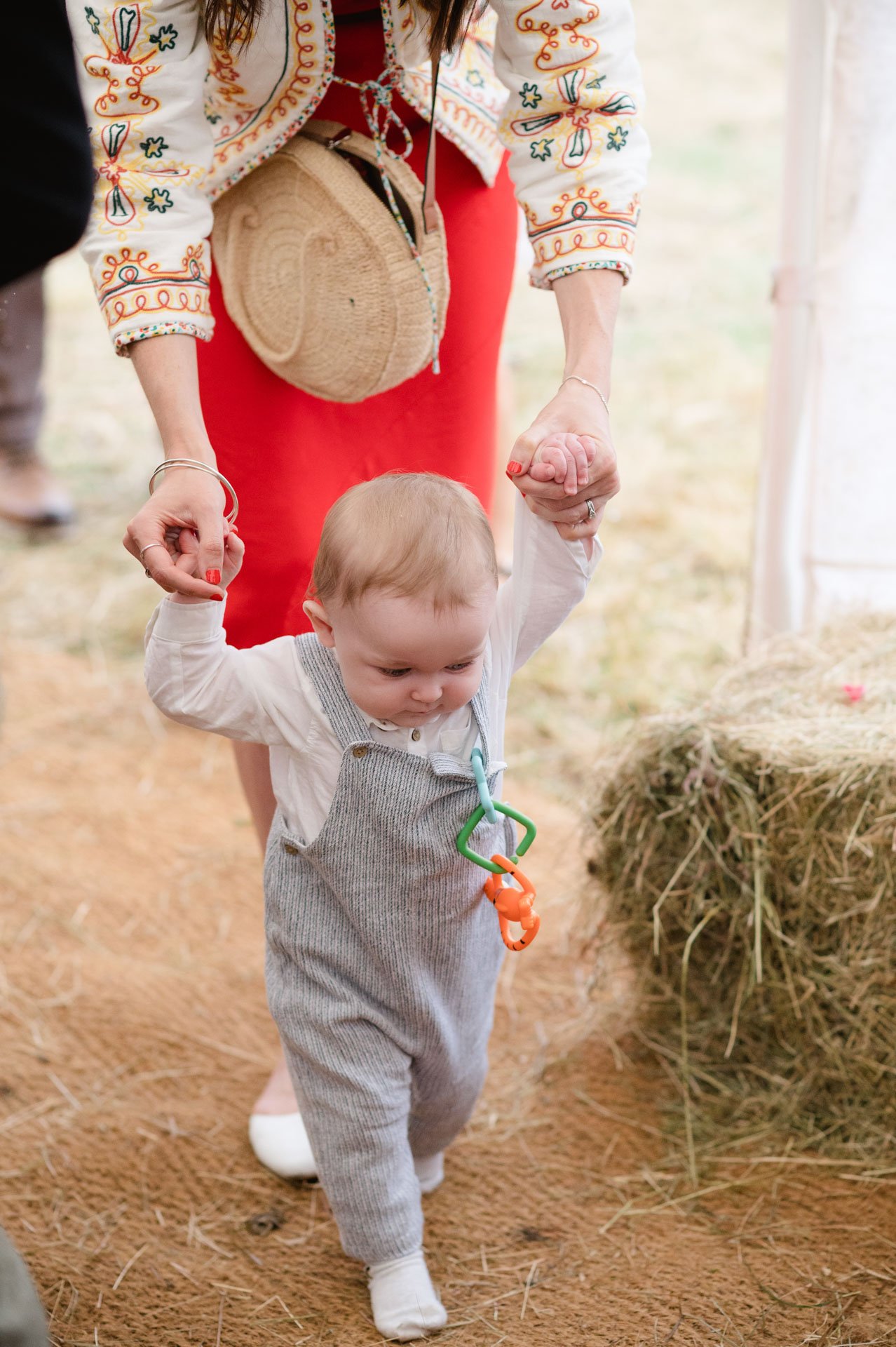 A toddler walking across the tipi floor after the ceremony