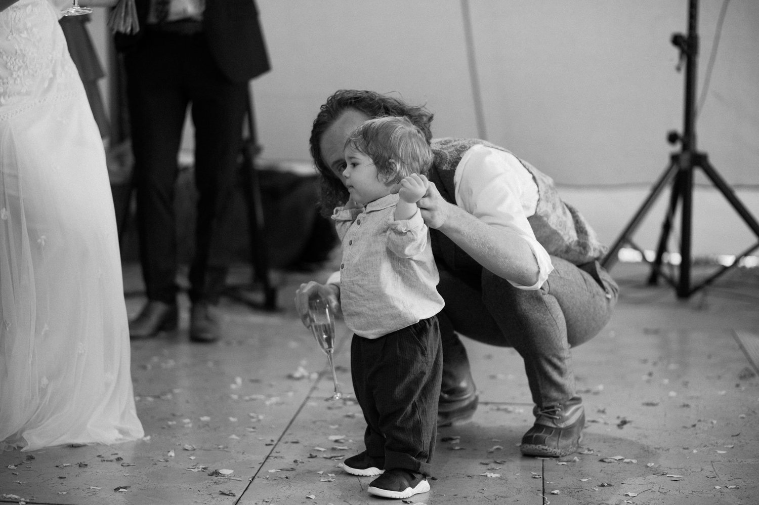 A young child kissing an adult hand during the reception