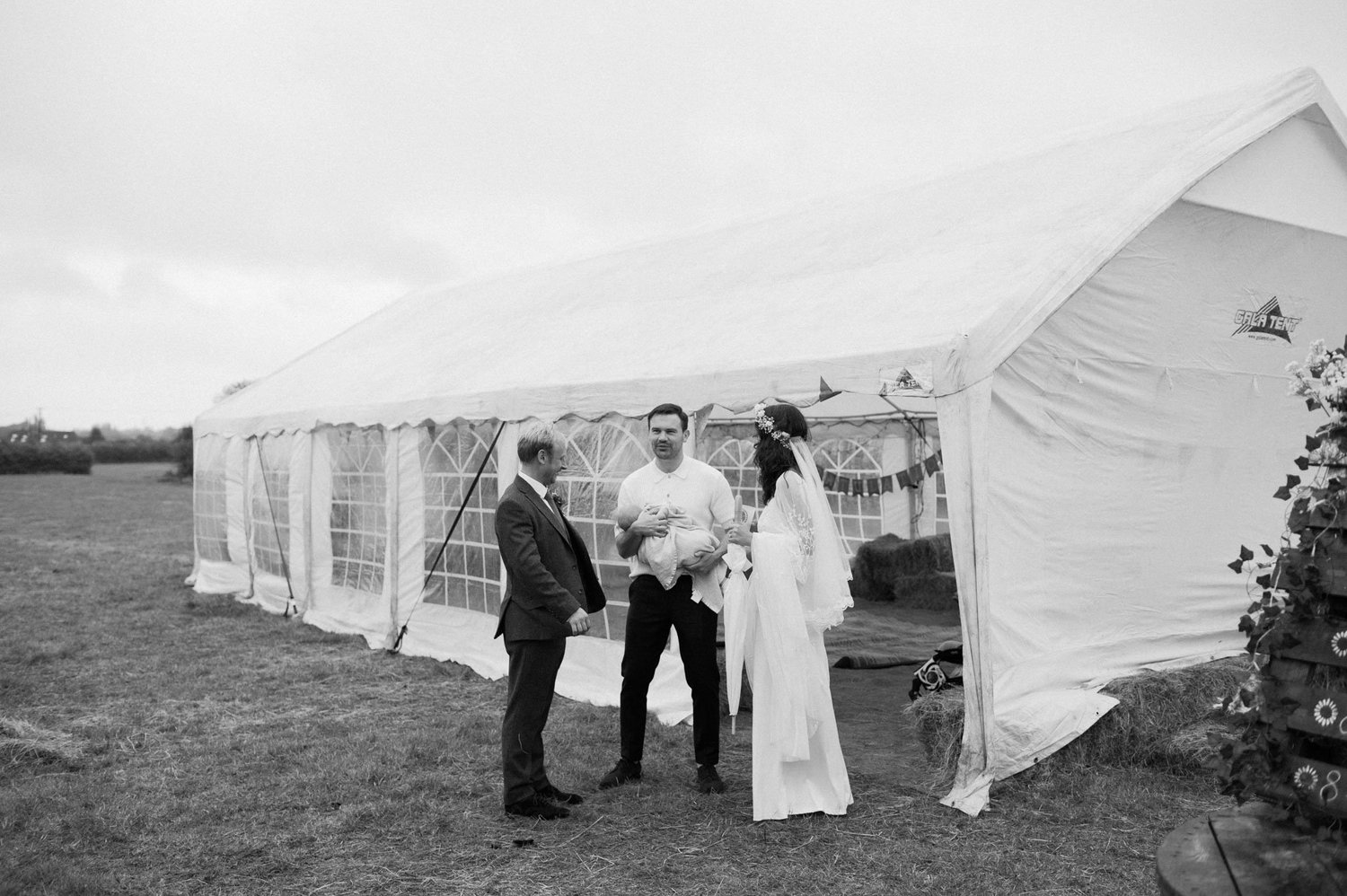 Hannah and Alex talking with a guest outside the marquee