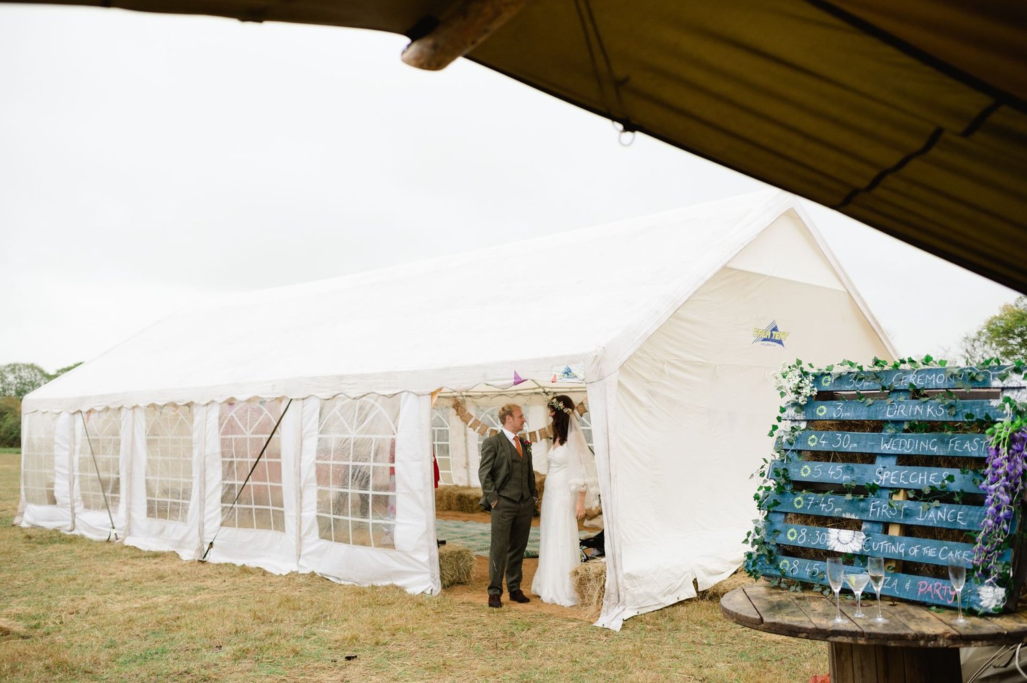 Guests standing outside the marquee beside stacked blue crates