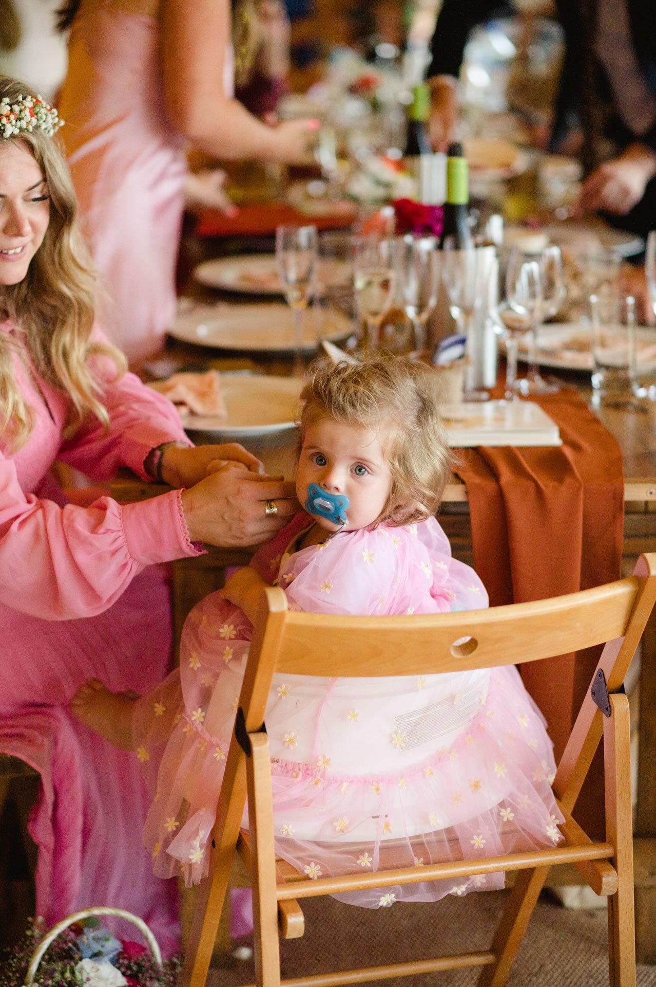 A little girl sitting at the wedding breakfast table