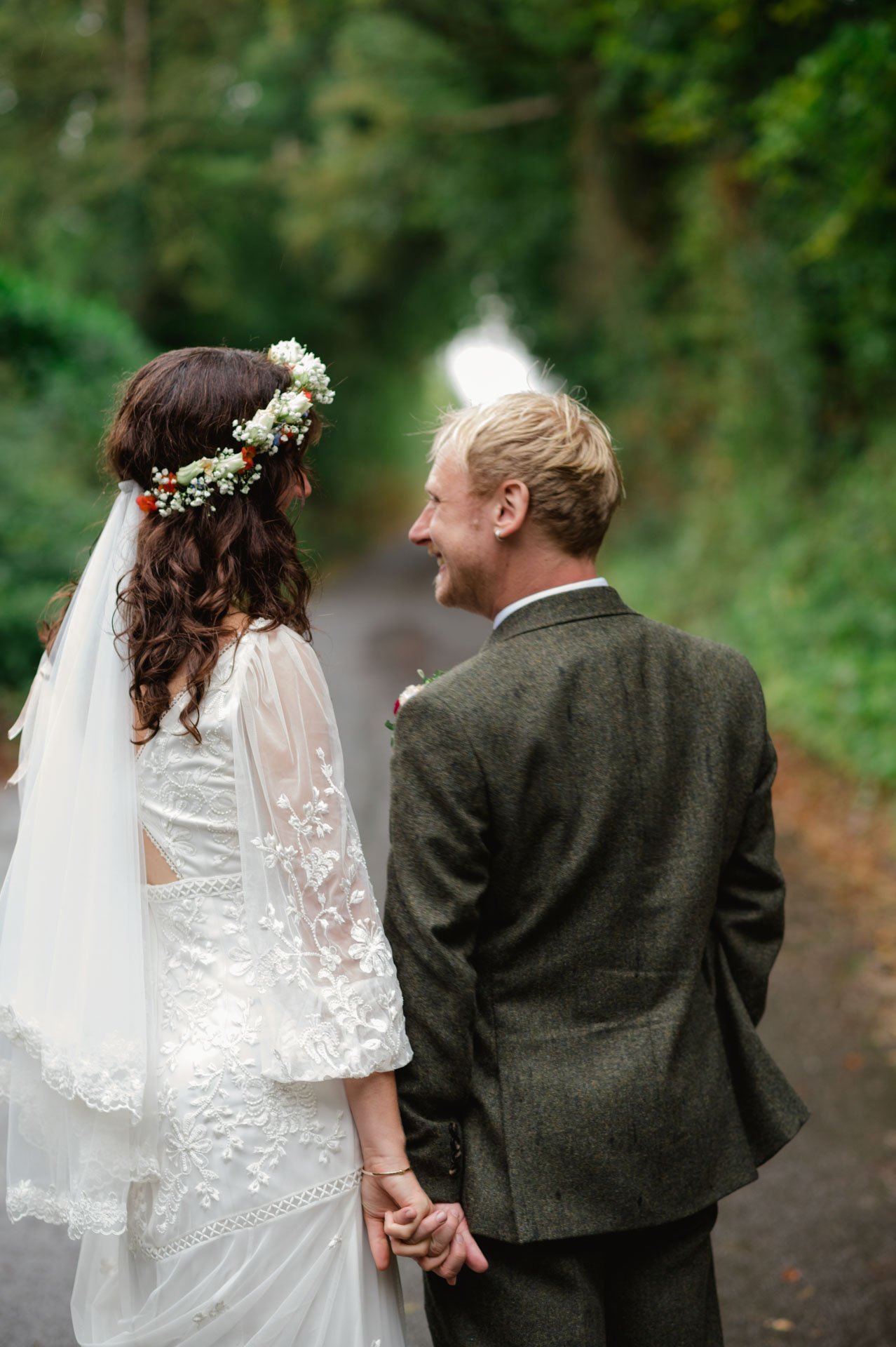 Hannah and Alex holding hands on a quiet country lane