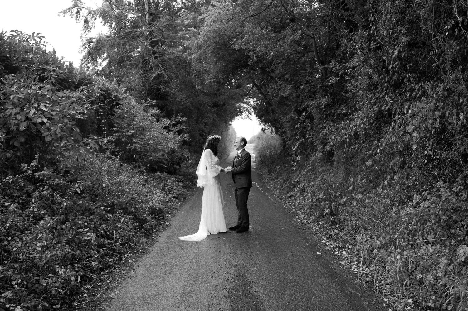 Hannah and Alex standing in the middle of the country lane