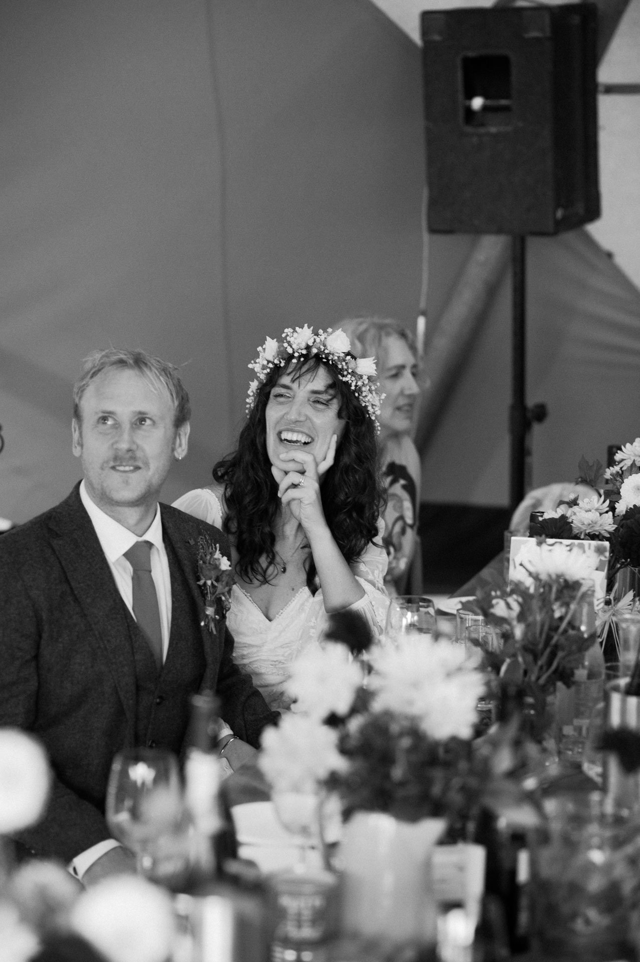 Hannah speaking into a microphone during the wedding speeches