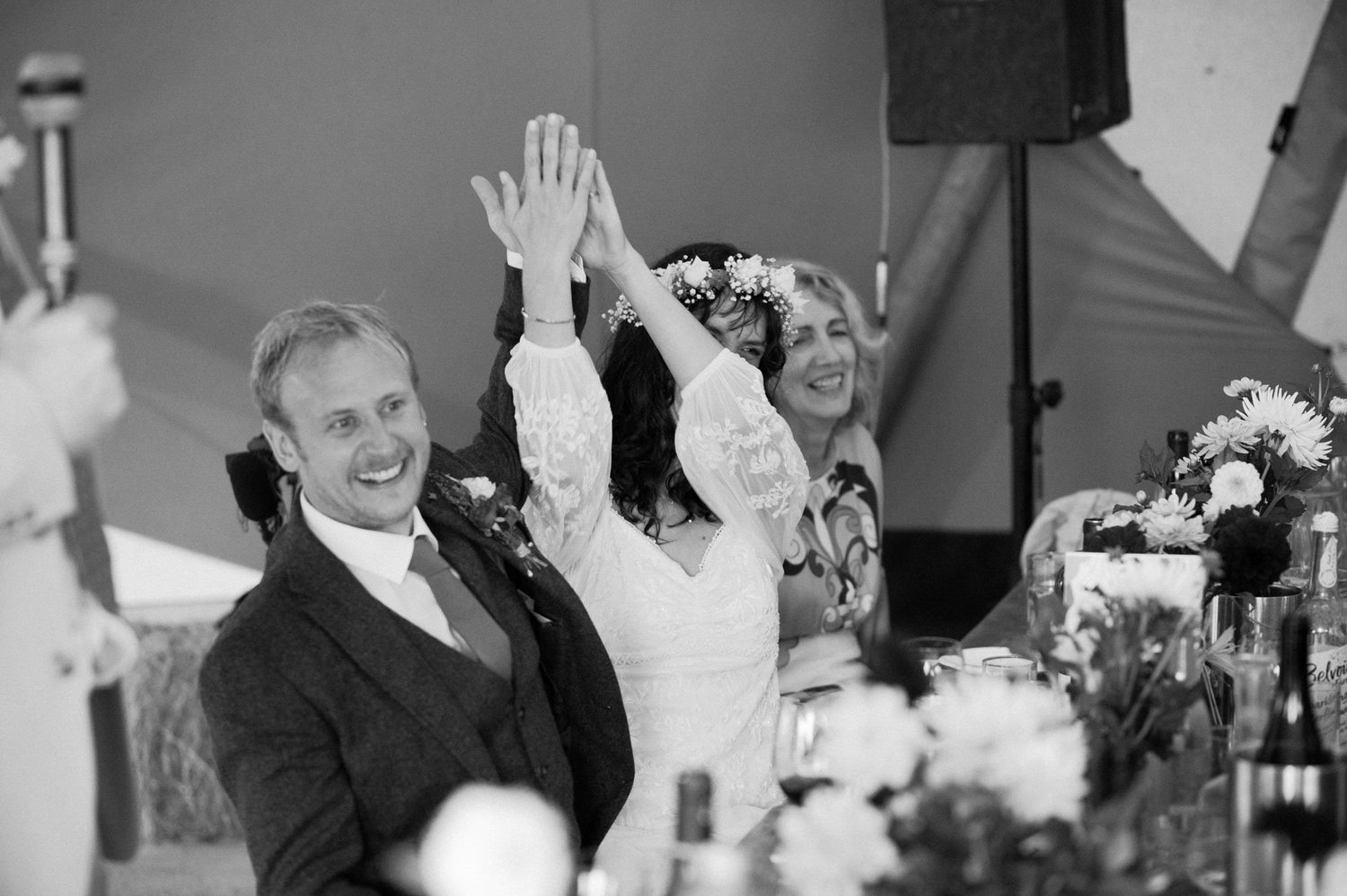 Hannah and Alex high-fiving during the wedding breakfast speeches