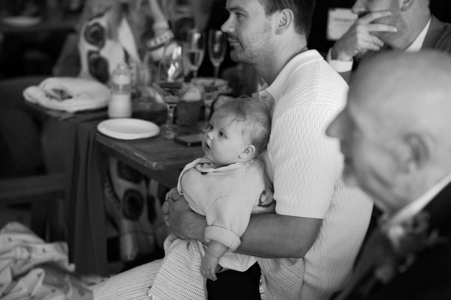 Guests smiling with a baby during the speeches