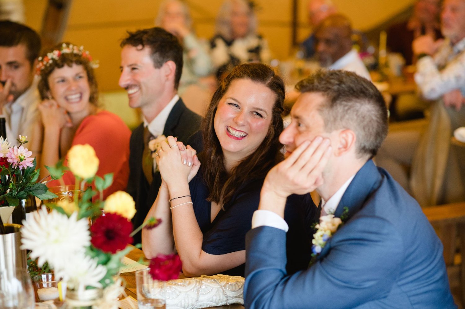 Guests smiling at the wedding breakfast table