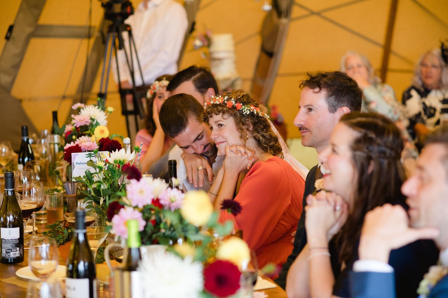 Guests at the flower-filled top table listening to speeches