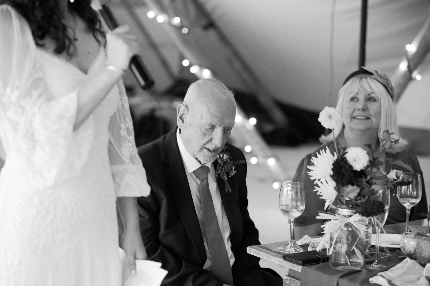 Guests listening closely while Hannah speaks at the reception