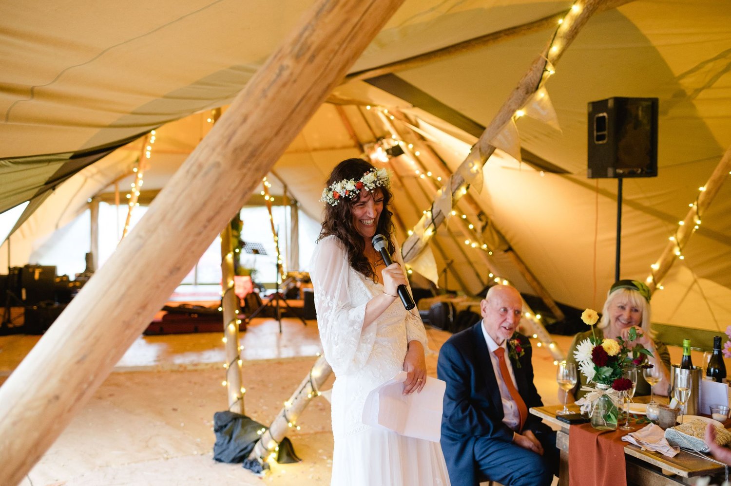 Hannah delivering a speech beside the top table