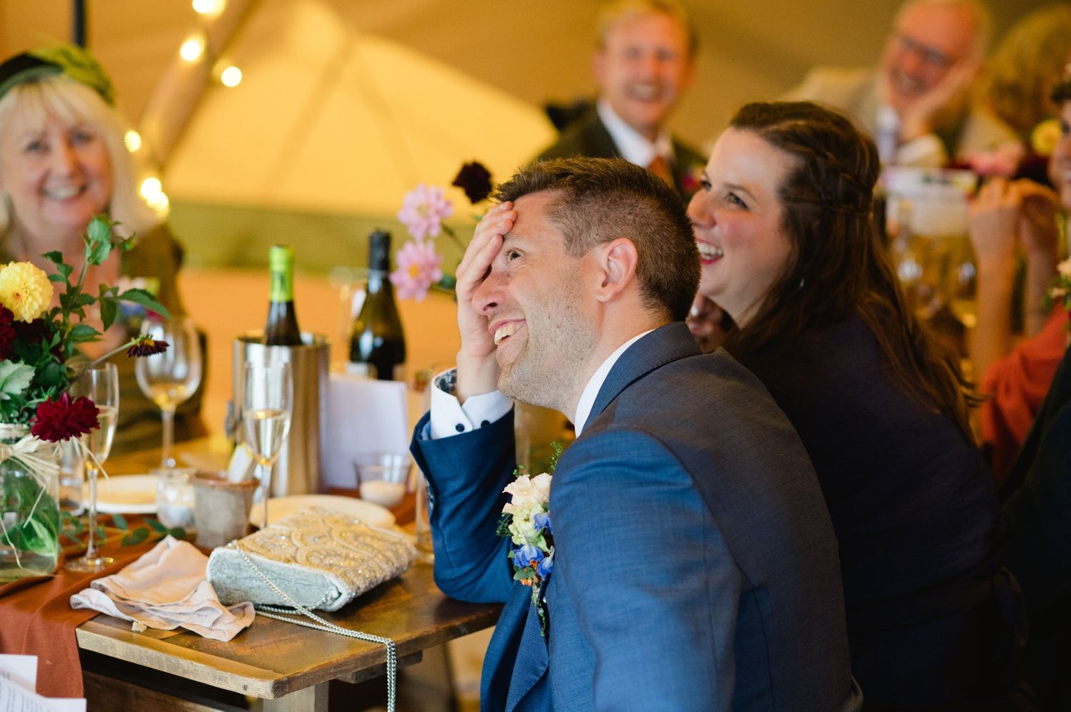 Alex laughing with guests during the reception speeches