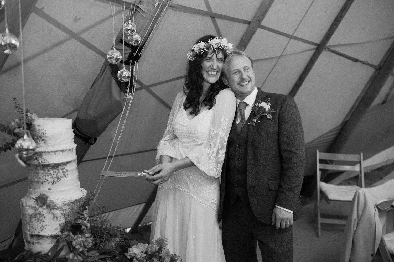 Hannah and Alex standing beside their textured wedding cake
