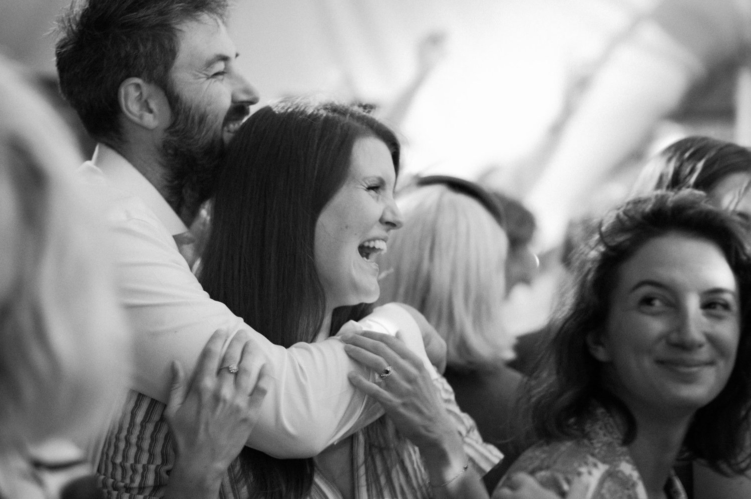 Guests laughing together during the evening reception