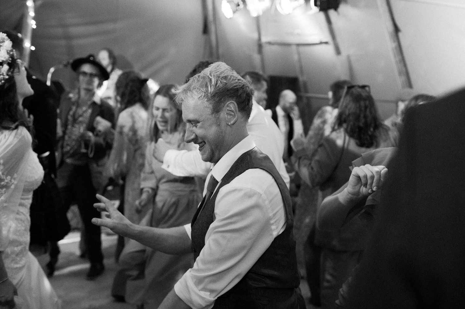 A guest dancing in the crowd at the evening party