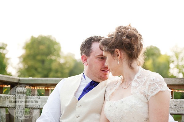 bride and groom by lake